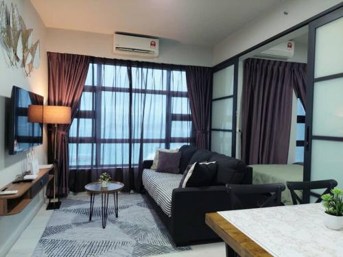 a living room with a couch and a table at J'Stay Seaview Suite Jesselton Quay Kota Kinabalu in Kota Kinabalu