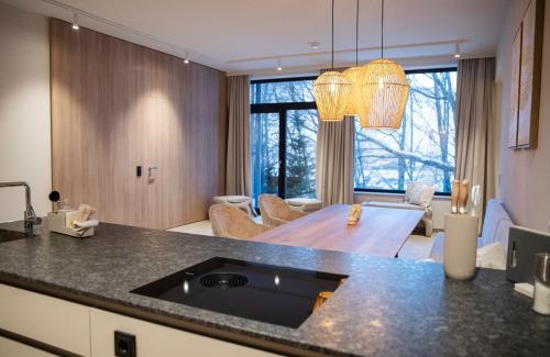 a kitchen and living room with a dining room at Appartement Chalet Saalbach in Saalbach Hinterglemm