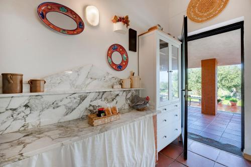 a kitchen with white marble counter tops and a doorway at Villa Ada in Cozze
