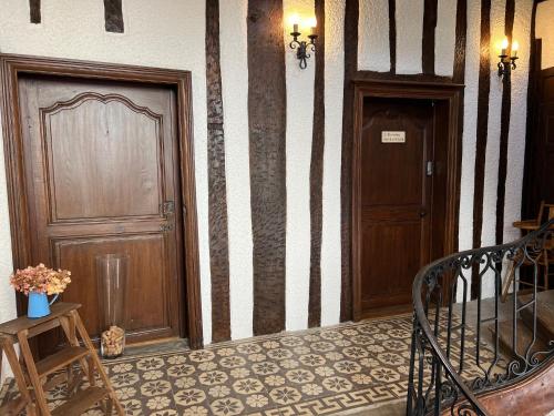 a hallway with two doors and a staircase in a building at Chez Simone et Marguerite in Luzy