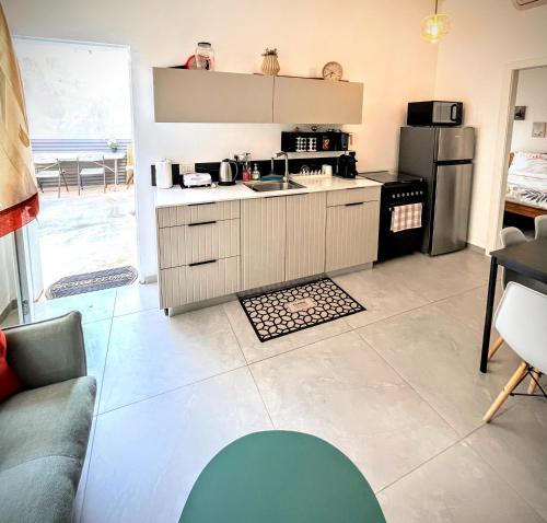 a kitchen with a sink and a refrigerator at Up the Hill in Tiberias