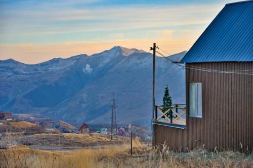 a building with a window with a christmas tree on it at Snow Heaven for 10 in Gudauri