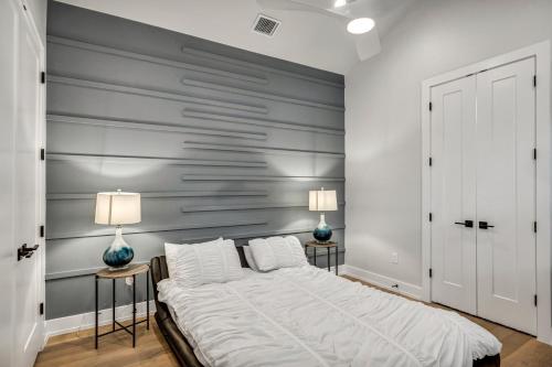 a bedroom with a bed and two tables with lamps at Queen Bed with Attached Private Bath in Austin