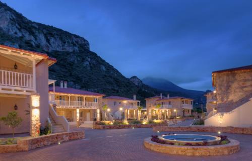 a town at night with mountains in the background at Kyniska Palace Conference & Spa in Mystras