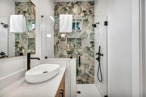 a white bathroom with a sink and a shower at Queen Bed with Attached Private Bath in Austin