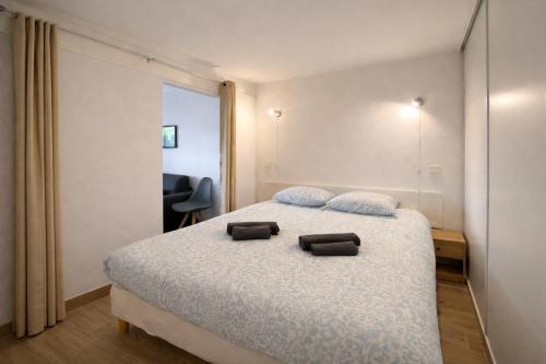 een slaapkamer met een bed met twee kussens erop bij T2, swimming pool, Tennis MC in Beausoleil