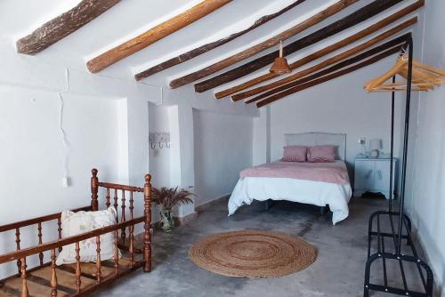 a bedroom with a bed in a white room at Casa Lola in Benaocaz