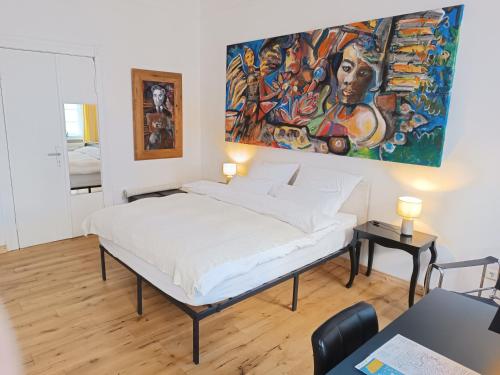 a bed in a room with a painting on the wall at Studio Berlin Center in Berlin