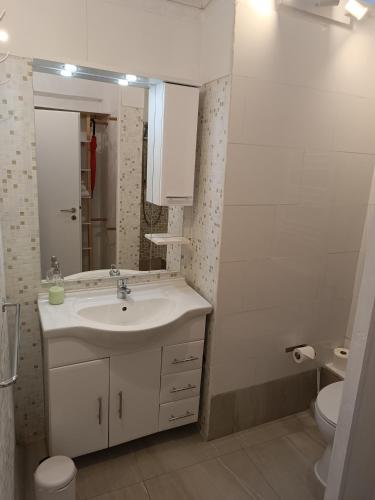a white bathroom with a sink and a toilet at Studio Berlin Center in Berlin