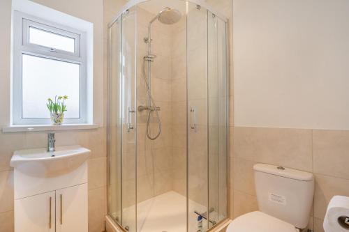 a bathroom with a shower and a toilet and a sink at 4 Bed in Killay oc-c28372 in Killay