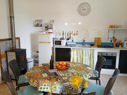 una cucina con un tavolo con una ciotola di frutta sopra di Casa Tosca a San Pietro