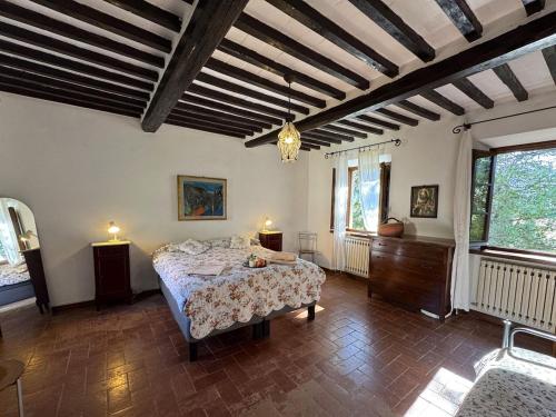 a bedroom with a bed in a room with wooden ceilings at Allo Scoiattolo in Lucca