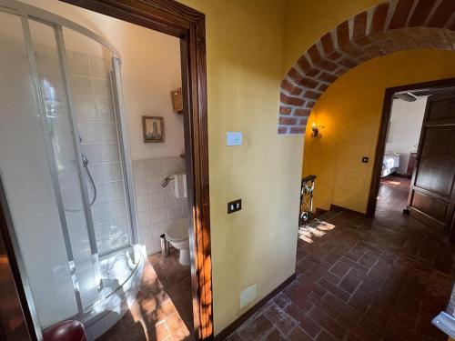a bathroom with a walk in shower next to a hallway at Allo Scoiattolo in Lucca