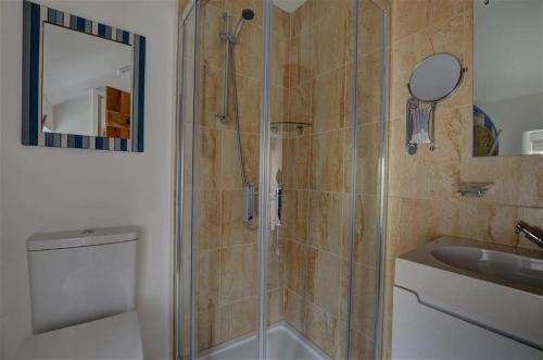 a bathroom with a shower and a toilet and a sink at 3 Bed in Croyde oc-beren in Croyde