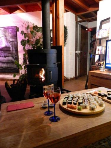 a table with a plate of food and a glass of wine at Villa West heaven Valley Gent in Ghent