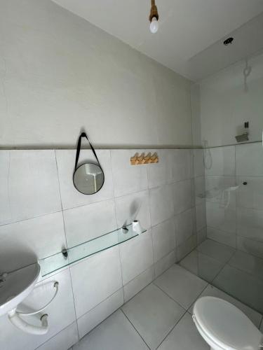 a bathroom with a toilet and a sink and a mirror at HOSTEL ARACAJU Sequência Surf Paradise POUSADA in Aracaju