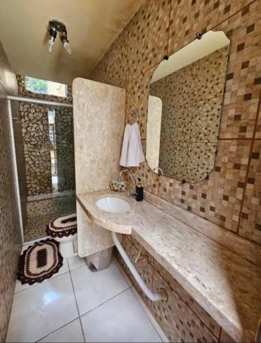 a bathroom with a sink and a mirror at Casa amanhecer in Triunfo