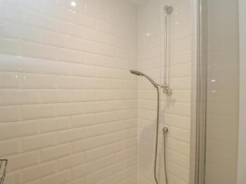 a shower with a glass door in a bathroom at Flat 6 in Tetbury