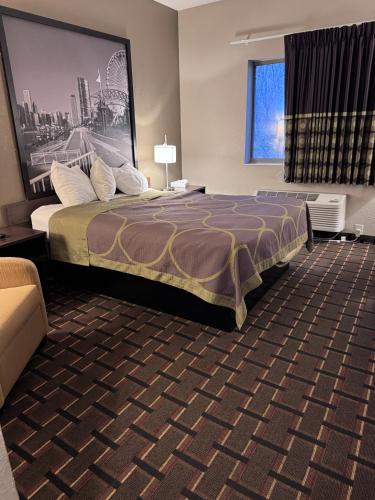 a hotel room with a large bed and a window at Super 8 by Wyndham Valparaiso in Valparaiso