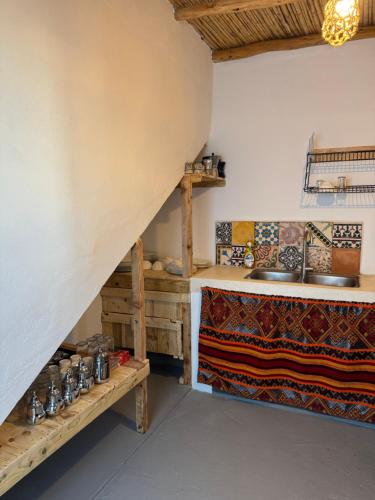 a kitchen with a sink and a counter in a room at Atlantic refuge rooms in Essaouira