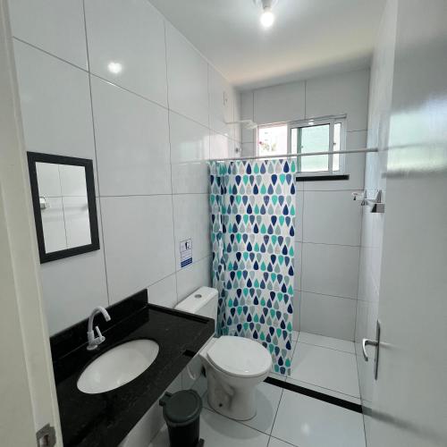 a bathroom with a sink and a toilet and a shower at Casa Sol Nascente in Aquiraz