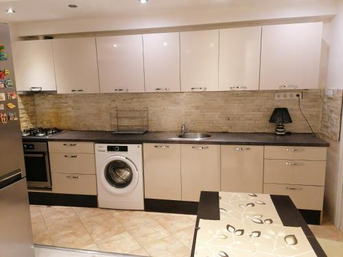 a kitchen with a washing machine and a sink at Guest House Plovdiv in Plovdiv