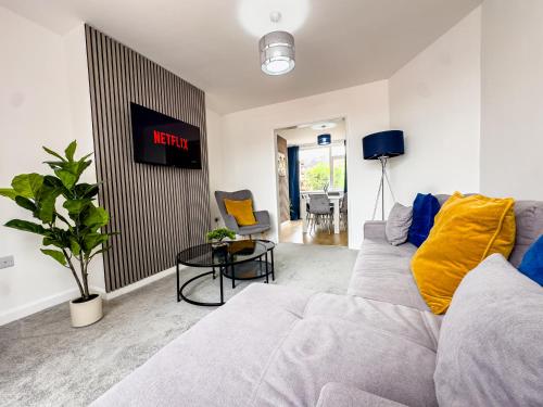 a living room with a couch and a table at Modern 3 Bedroom Home, 6 beds, Free Parking, 500MBS, Netflix, Near Coventry City Centre & Hospital, Contractors, Families, Apple Air Play in Coventry