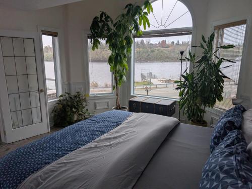 a bedroom with a bed and a large window at Waterfront apartment in Gatineau