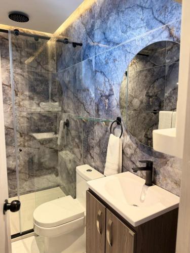 a bathroom with a toilet and a sink at Del Mar City View in Cartagena de Indias
