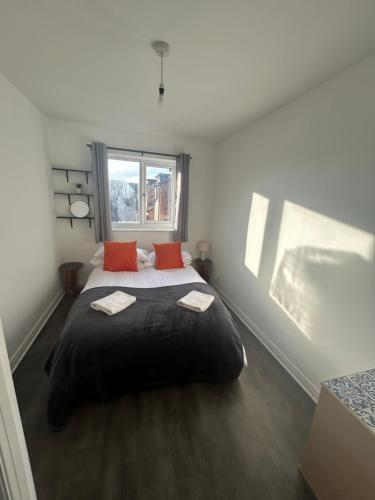 a bedroom with a large bed with two red pillows at Northgate House in Chester