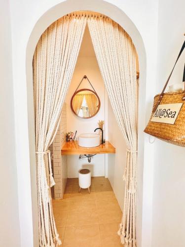 a bathroom with a sink and a mirror at All at Sea Kohlarn in Ko Larn