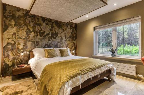 a bedroom with a bed and a window at Gate Lodge in Castle Douglas