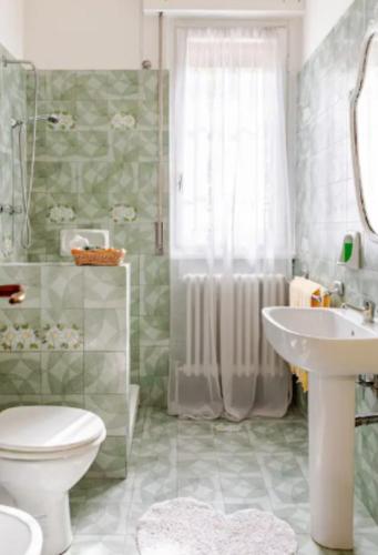 a bathroom with a toilet and a sink and a shower at Ca`del Fuin in Seregno