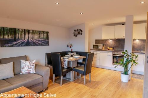 a kitchen and living room with a table and chairs at Haus Panorama in Brixen im Thale