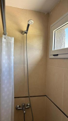 a shower head in a bathroom with a window at El Atardecer Complejo Turístico in San Rafael