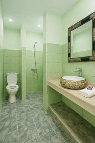 a bathroom with a toilet and a sink and a mirror at chez Nael in Ouarzazate