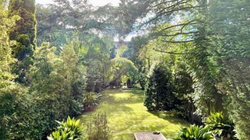 a garden with a bench in the middle of it at Top Floor Apartment Vondelpark in Amsterdam