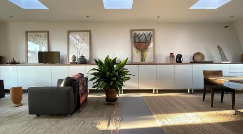 a living room with a couch and a table at Top Floor Apartment Vondelpark in Amsterdam