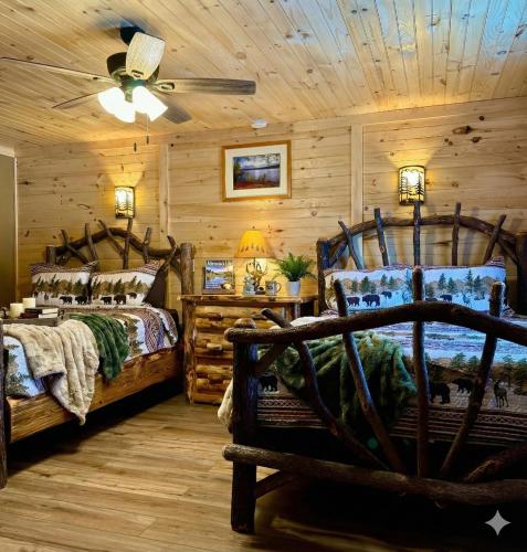 a bedroom with two beds and a wooden ceiling at Lake Haven Motel in Lake George