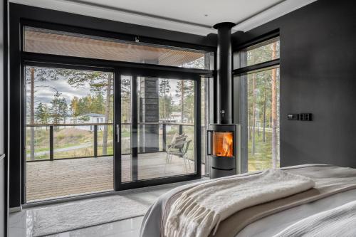 a bedroom with a fireplace in front of a window at Casa Pickala - The Luxury of life in Hovgård