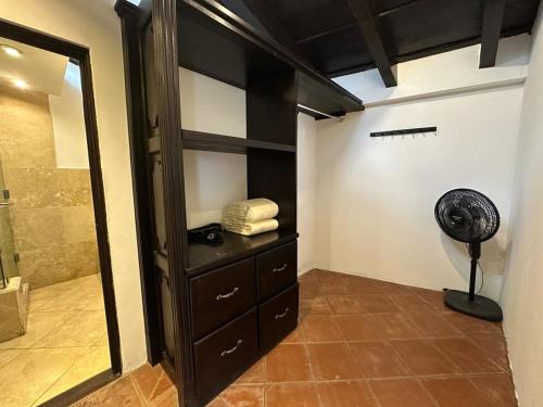 a room with a closet with a fan in it at Lovely house in Antigua Guatemala for 7 guests in Cataltzul