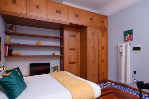 a bedroom with a large bed with wooden cabinets at ArtStay Apt Sempione, Near Metro, City Centre in Milan
