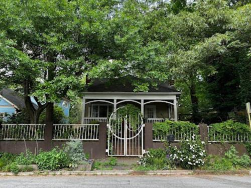 a small house with a fence and a gate at Charming 3 bedroom Home in Decatur