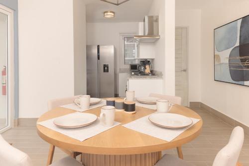 a dining room with a table and a kitchen at Brisas del Mar by Playa Caracol Resorts in Punta Chame