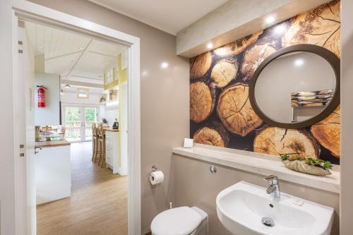a bathroom with a sink and a mirror on a wall at Squirrel Lodge 43 with Hot Tub in Newton Stewart