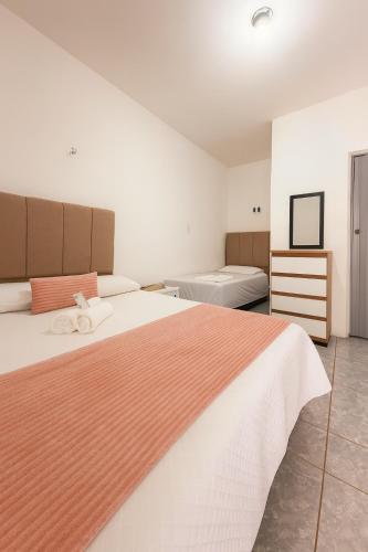 two beds in a room with two beds at Karem Suítes in Canoa Quebrada