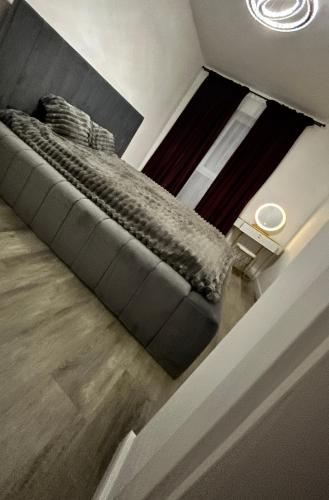 an overhead view of a couch in a living room at Luxury Apartment private parking in Craiova