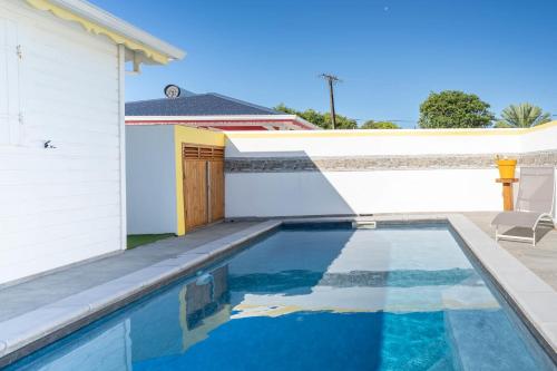 a swimming pool in front of a house at Villa Guenaslo 1 in Saint-François