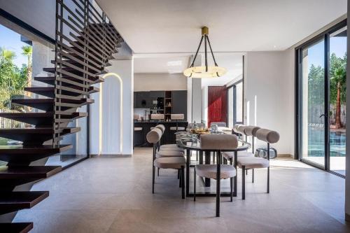 a dining room and kitchen with a spiral staircase at Palais Zahira in Marrakesh