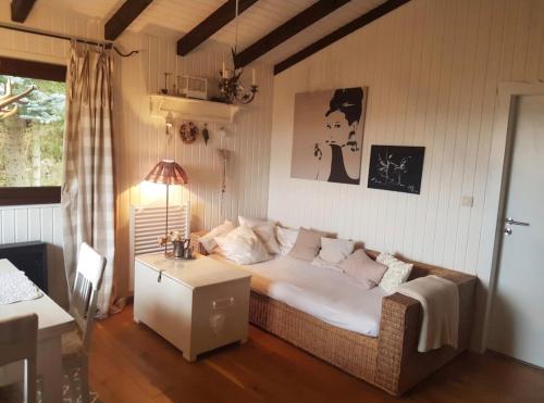 a bedroom with a bed and a table in it at Ferienhaus Bärenloch in Hilders